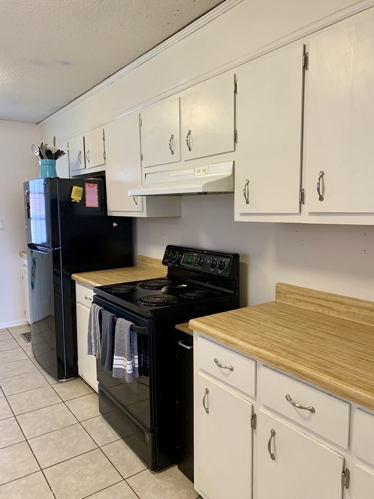 102 McDougal Road Fayetteville, TN 37334 - Photo 10 of 27 a kitchen with stainless steel appliances granite countertop a stove a refrigerator and cabinets