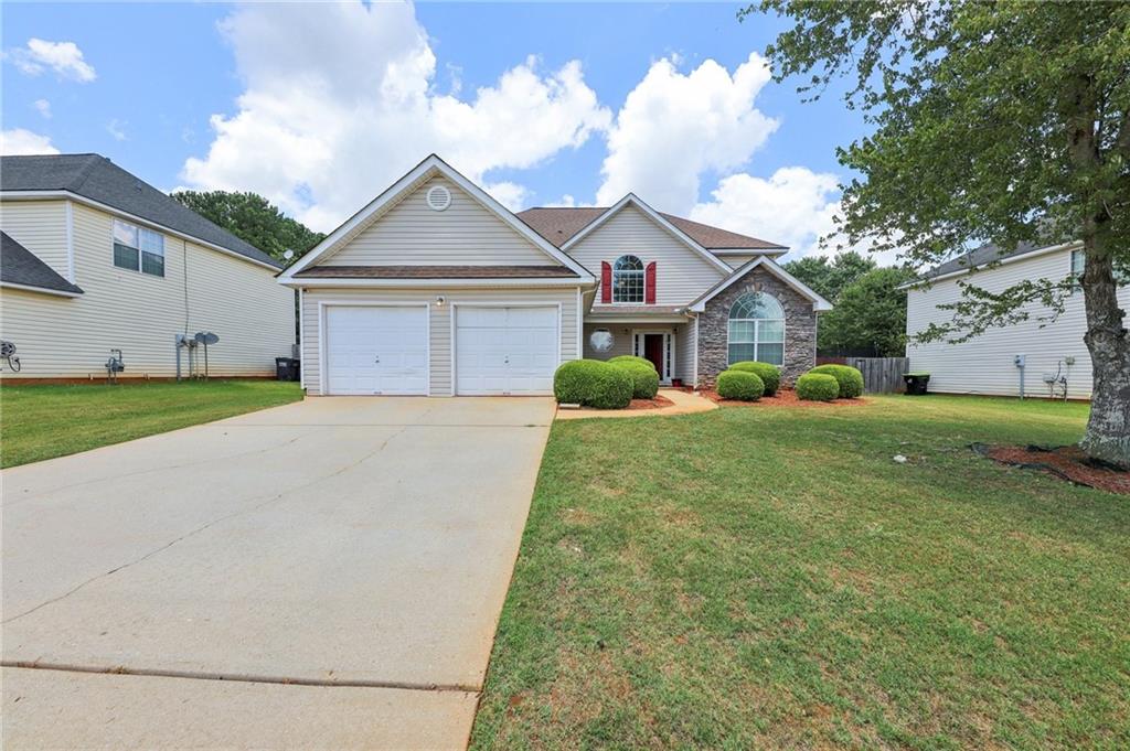 180 Spring Lake Terrace Covington, GA 30016 - Photo 1 of 1 a front view of a house with garden