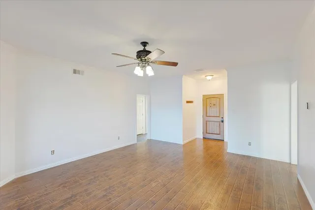 a front view of a house with yard and swimming pool