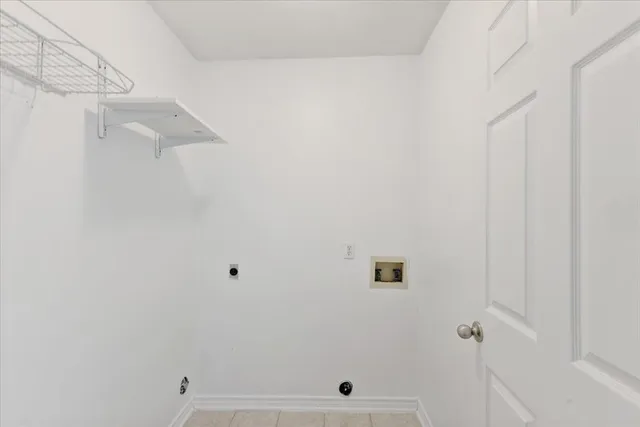 a view of an empty room with a staircase