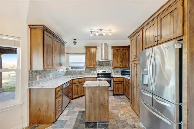 a view of a livingroom with a chandelier fan and wooden floor