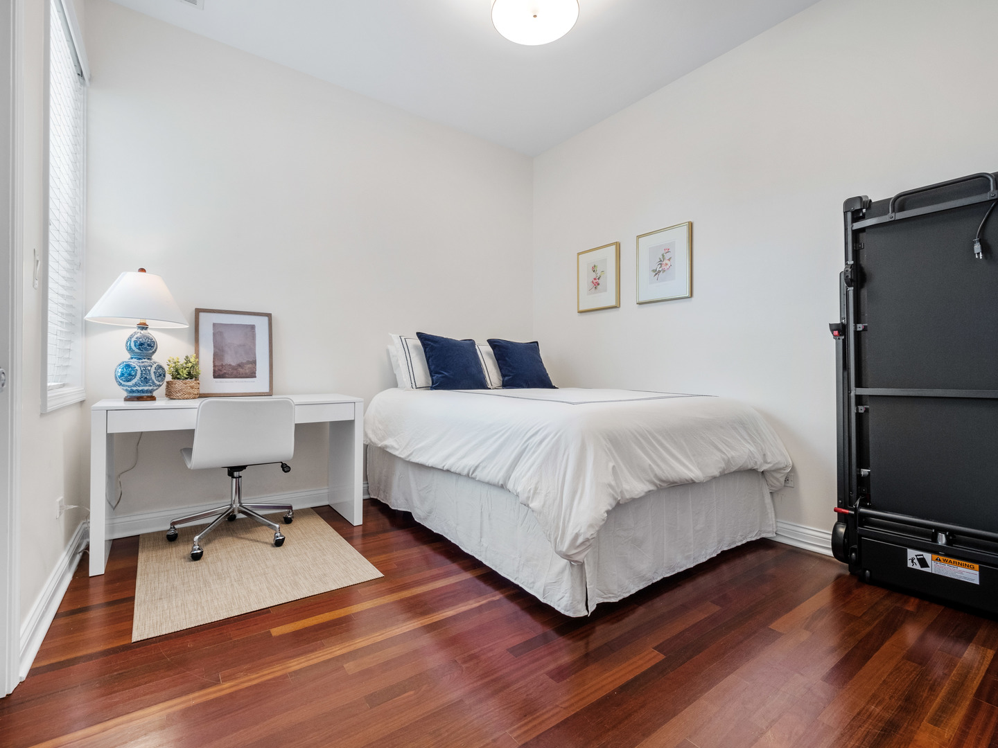 1925 West Irving Park Road, Unit 3 Chicago, IL 60613 - Photo 13 of 26 a bedroom with a bed window and a flat screen tv