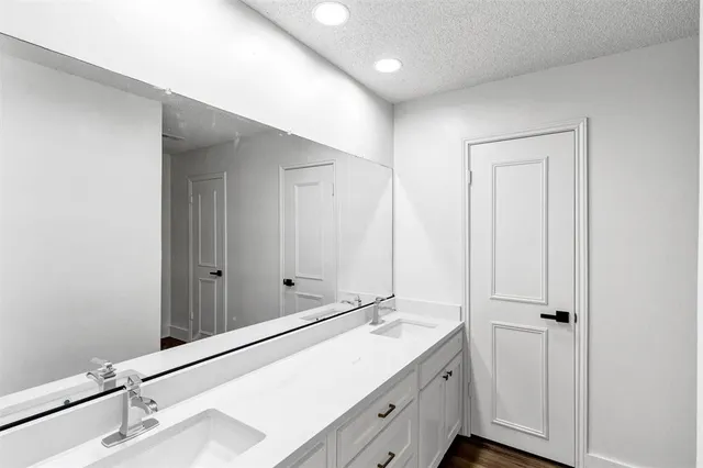 a bathroom with a double vanity sink and mirror