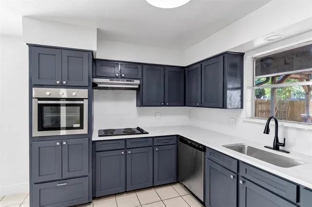 a kitchen with wooden cabinets and a sink
