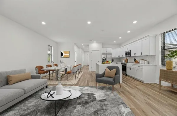 a living room with furniture kitchen view and a dining table