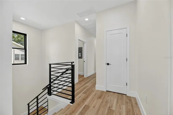 a view of a hallway with wooden floor and entryway