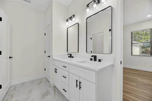 a bathroom with double sink and mirror