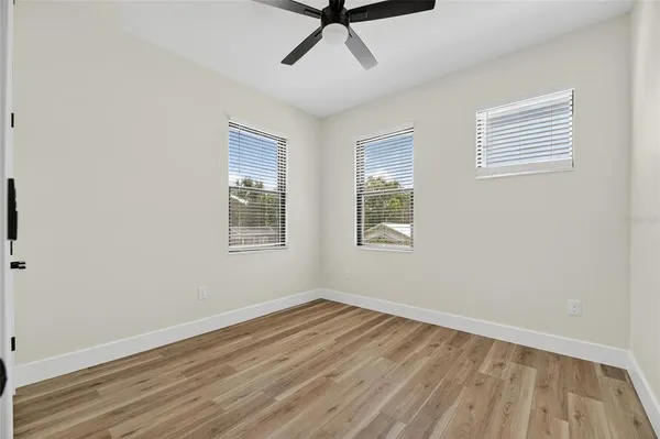 a view of a livingroom with wooden floor and a window