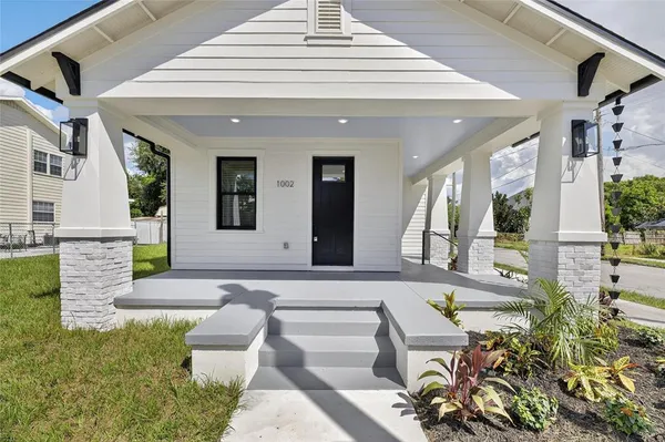 a front view of a house with outdoor seating