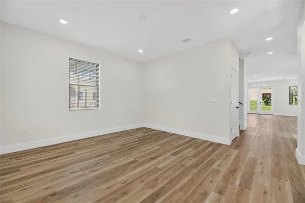 a view of empty room with wooden floor