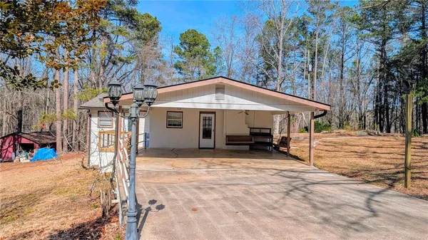 a view of a house with backyard porch and sitting area