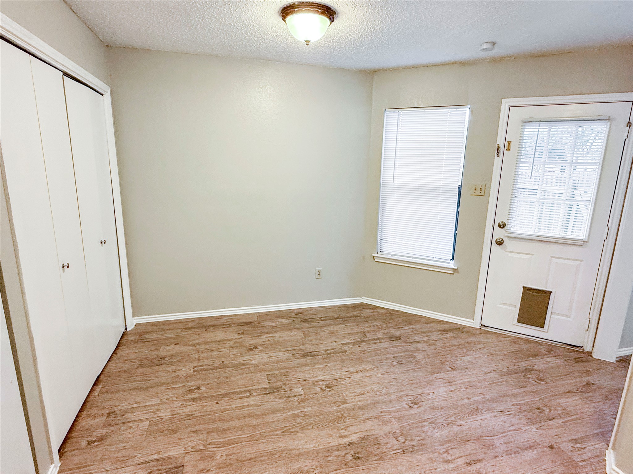 409 Rawhide Loop Round Rock, TX 78681 - Photo 6 of 14 Interior space featuring wood-finish flooring, light-toned walls, and white trim