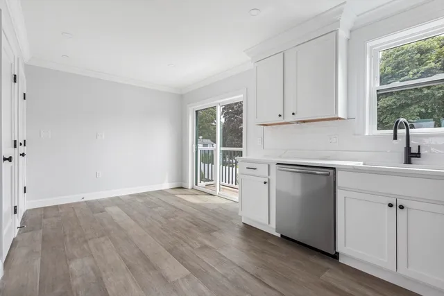 a kitchen with a hard wood floor and a window