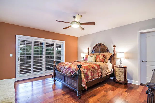 a bedroom with a bed and a large window