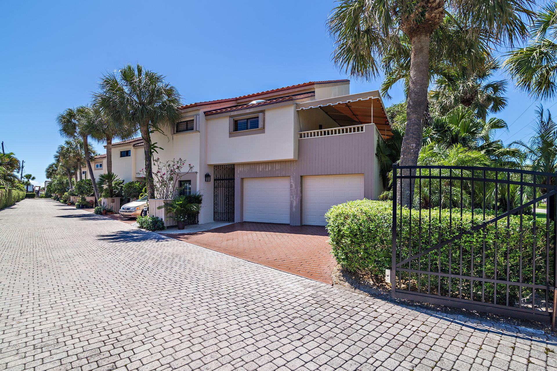 220 Celestial Way, Unit 1 Juno Beach, FL 33408 - Photo 16 of 35 a front view of a house with a garden
