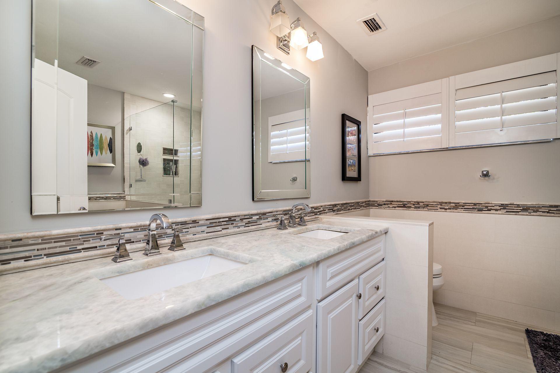 220 Celestial Way, Unit 1 Juno Beach, FL 33408 - Photo 17 of 35 a bathroom with a sink and a mirror