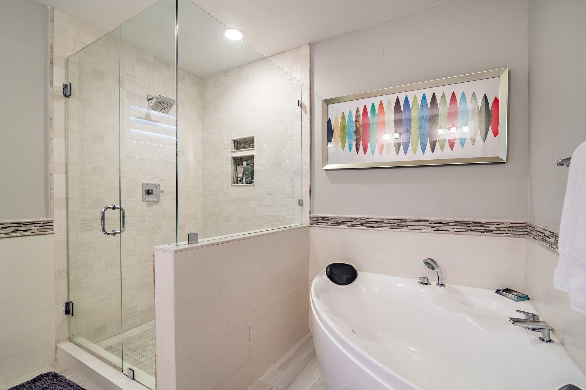 220 Celestial Way, Unit 1 Juno Beach, FL 33408 - Photo 18 of 35 a bathroom with a tub a sink and the shower