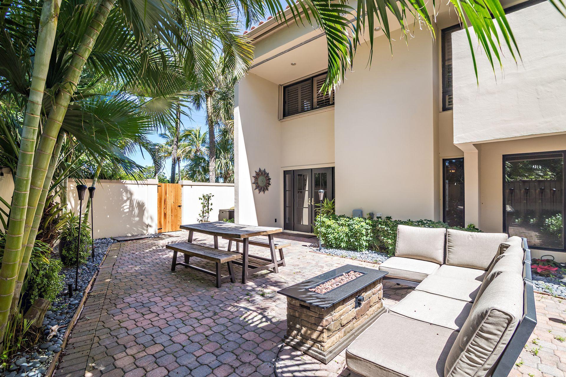 220 Celestial Way, Unit 1 Juno Beach, FL 33408 - Photo 24 of 35 a backyard of a house with outdoor seating