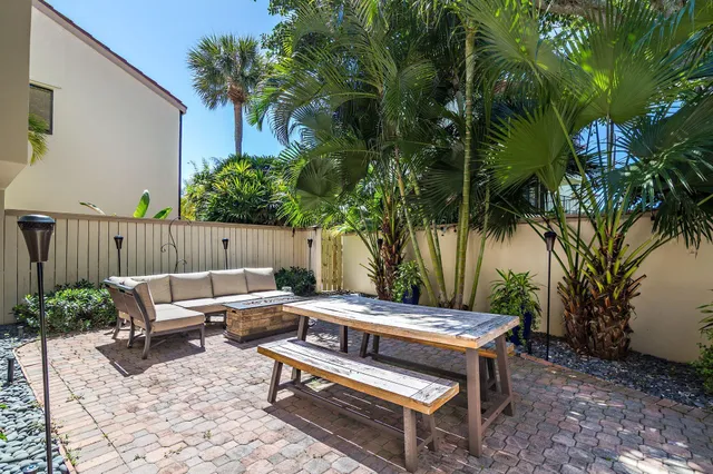 a outdoor sitting area with furniture and wooden floor