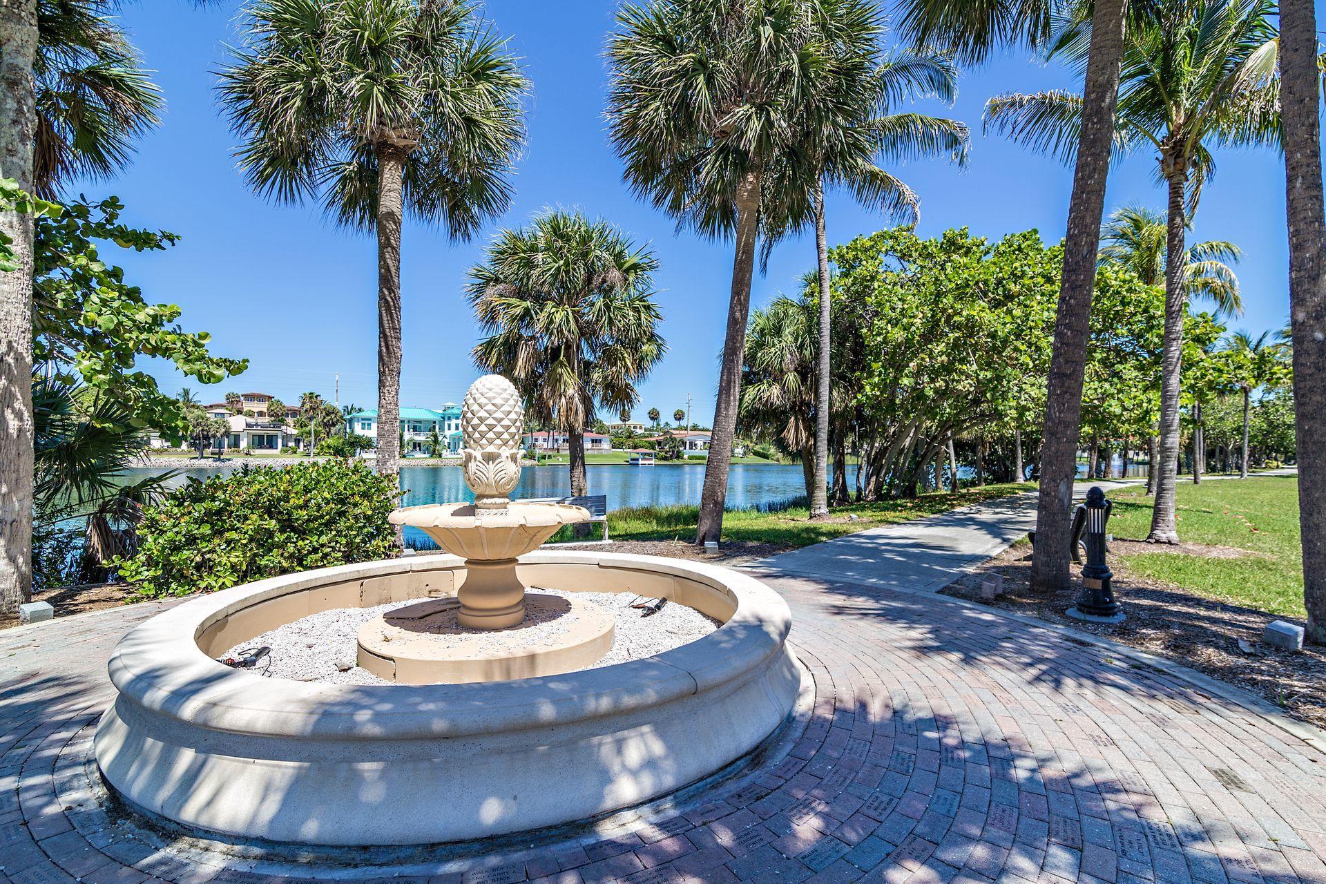 220 Celestial Way, Unit 1 Juno Beach, FL 33408 - Photo 27 of 35 a view of a swimming pool with a garden