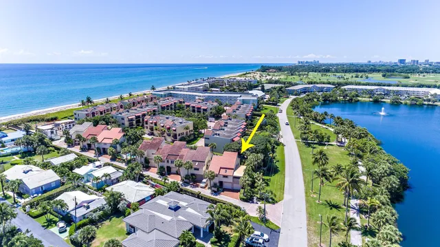 an aerial view of residential building and lake