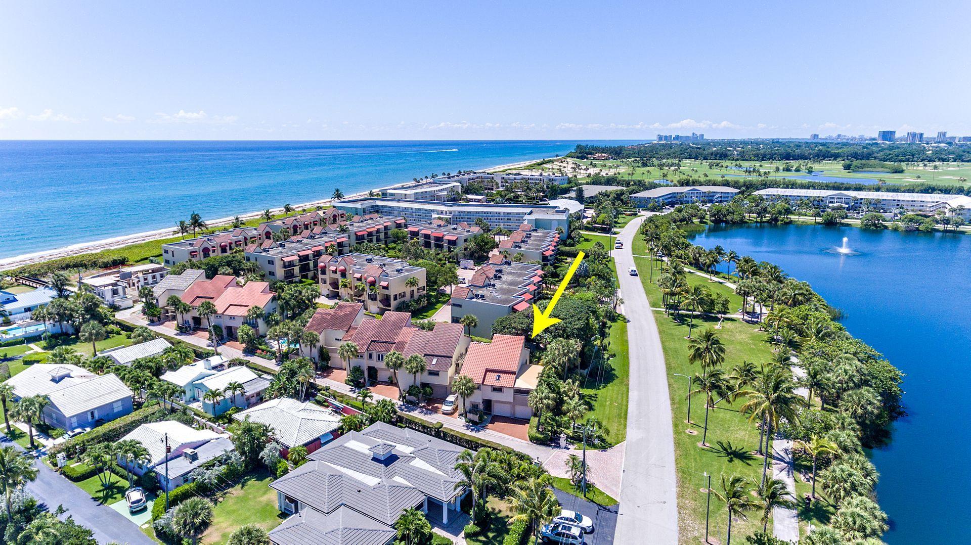 220 Celestial Way, Unit 1 Juno Beach, FL 33408 - Photo 30 of 35 an aerial view of residential building and lake