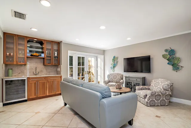 a living room with furniture a flat screen tv and a fireplace