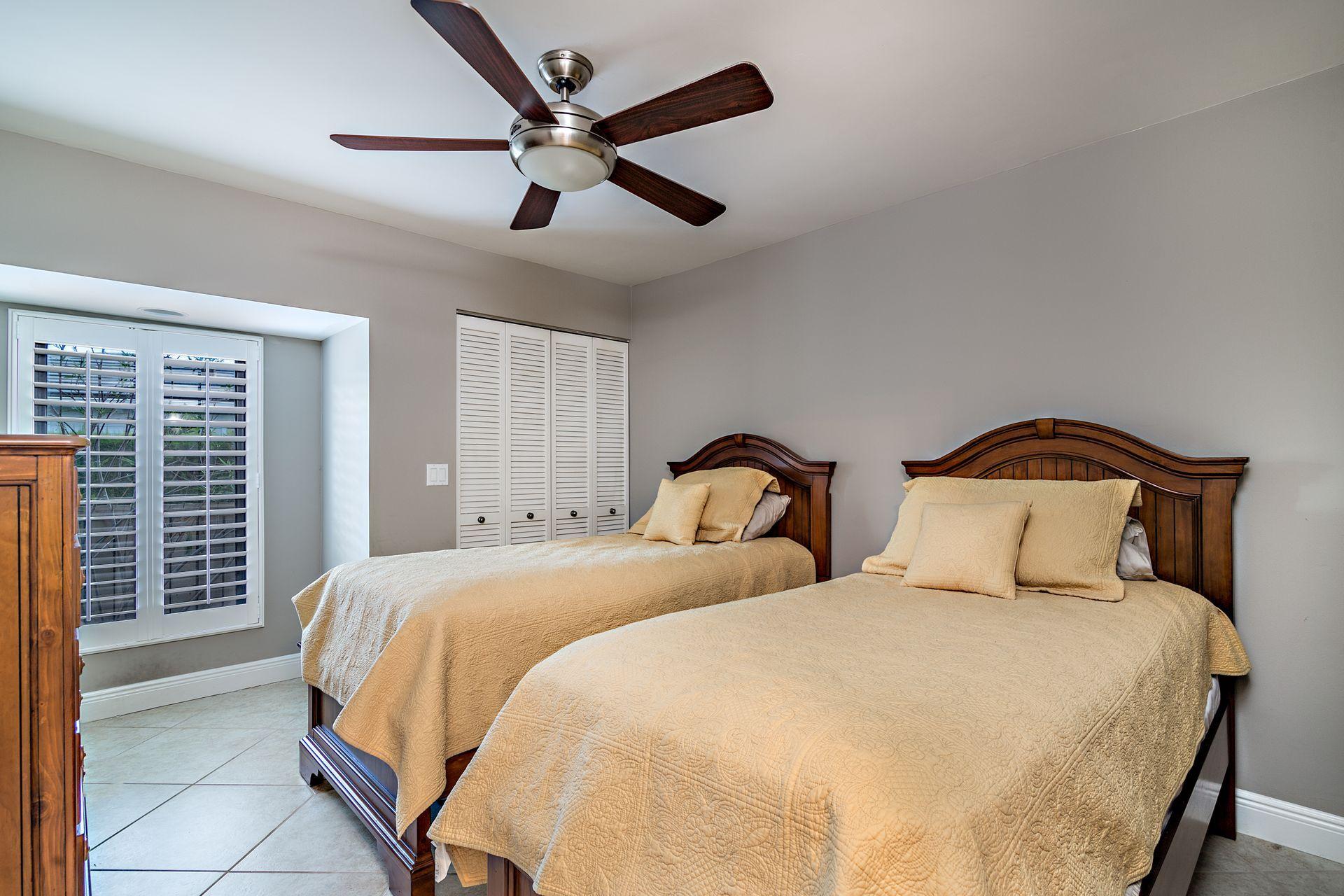 220 Celestial Way, Unit 1 Juno Beach, FL 33408 - Photo 10 of 35 a bedroom with double bed and a large window
