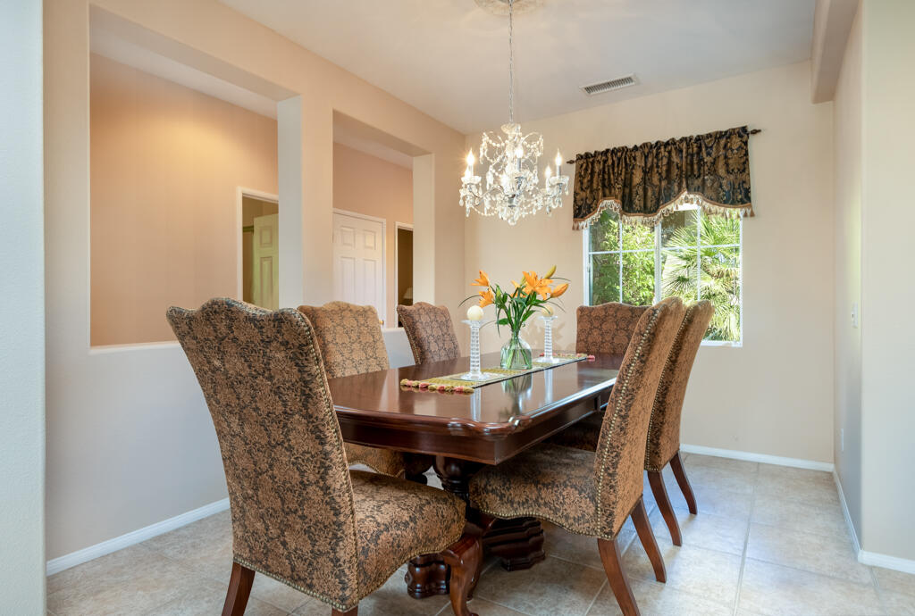 82539 Grant Drive Indio, CA 92201 - Photo 12 of 34 a dining room with furniture a chandelier and window
