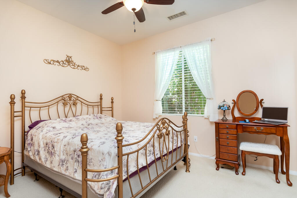 82539 Grant Drive Indio, CA 92201 - Photo 16 of 34 a bedroom with a bed and a chandelier