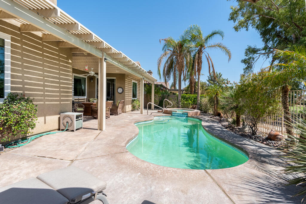 82539 Grant Drive Indio, CA 92201 - Photo 27 of 34 a view of a swimming pool with a lounge chair and palm trees