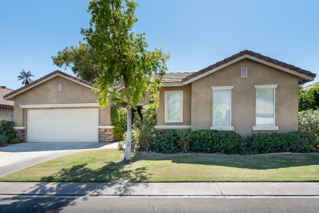 82539 Grant Drive Indio, CA 92201 - Photo 3 of 34 a front view of a house with garage and plants