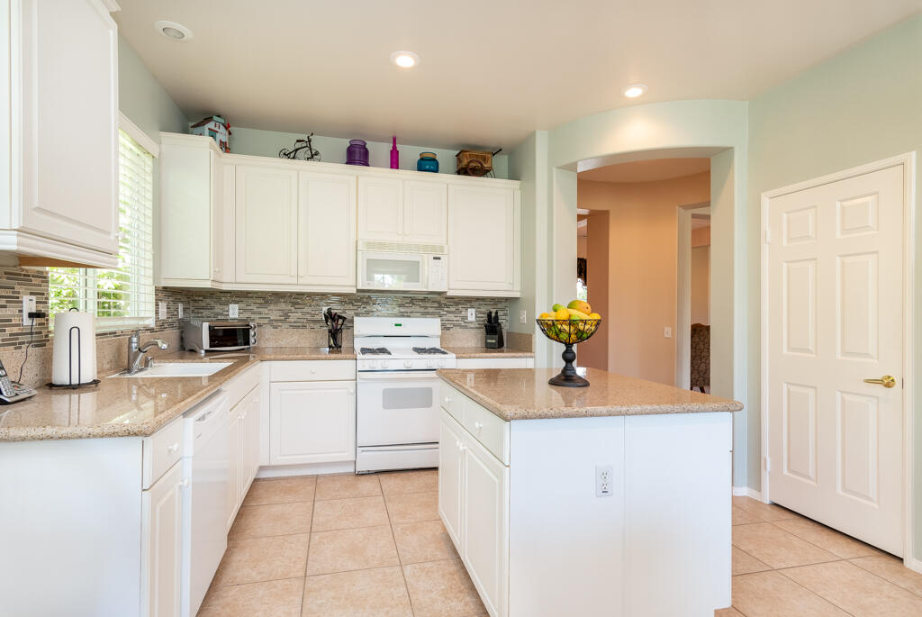 82539 Grant Drive Indio, CA 92201 - Photo 7 of 34 a kitchen with cabinets a sink and appliances