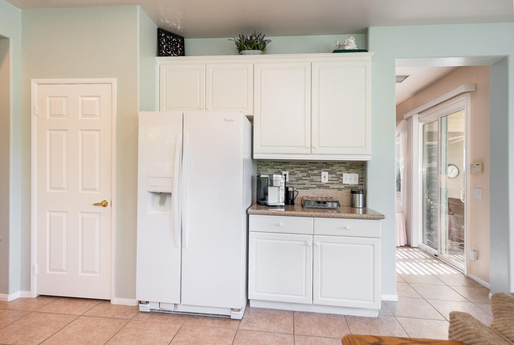 82539 Grant Drive Indio, CA 92201 - Photo 8 of 34 a kitchen with white cabinets and refrigerator