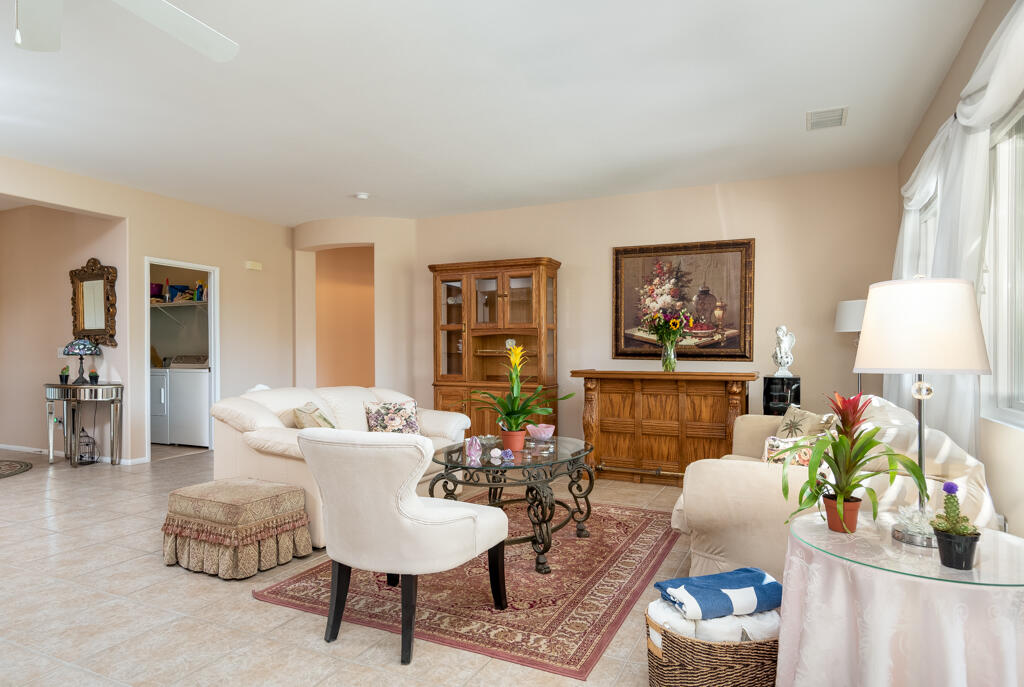 82539 Grant Drive Indio, CA 92201 - Photo 10 of 34 a living room with furniture and a potted plant