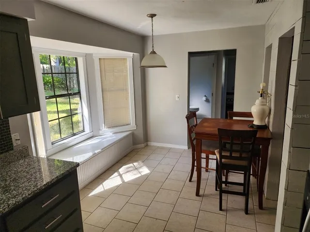 a dining room with furniture and window