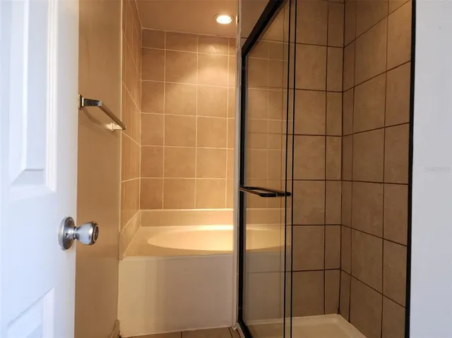 a bathroom with a tub and a shower