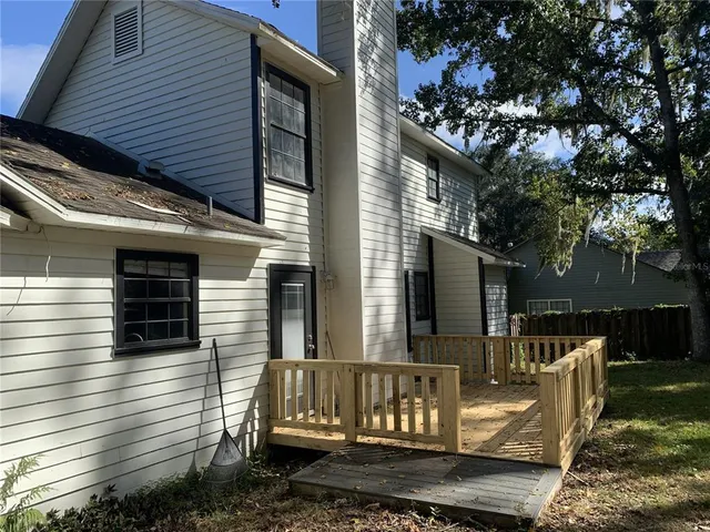 a view of a backyard with swimming pool