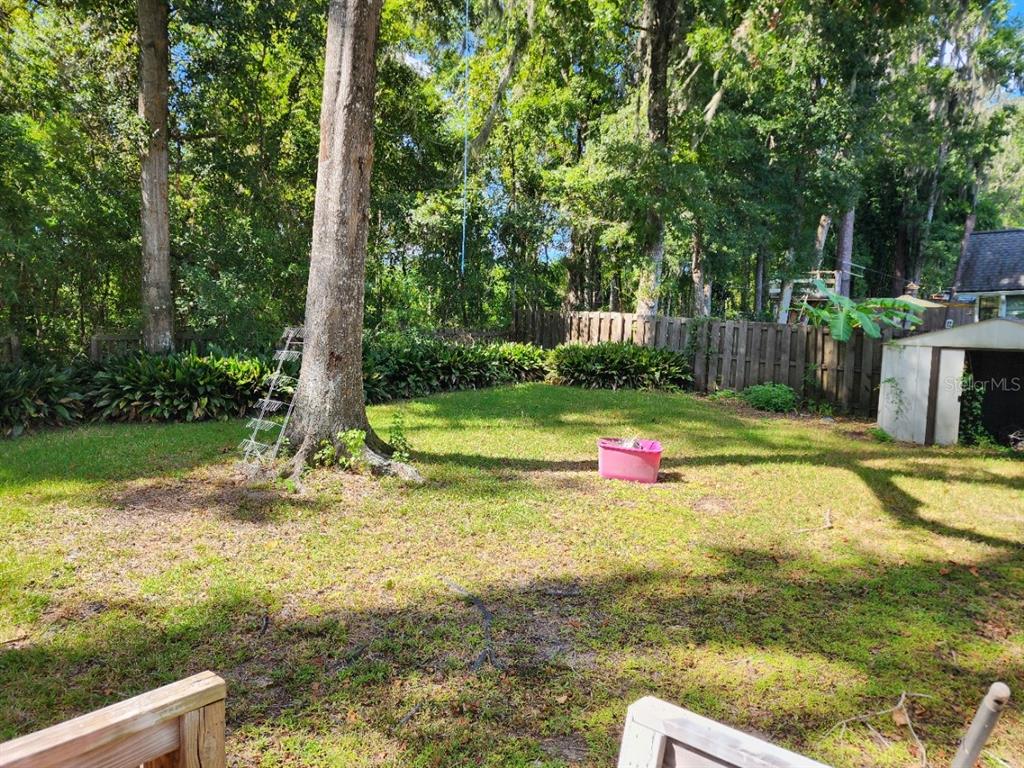 10911 Northwest 31st Place Gainesville, FL 32606 - Photo 24 of 27 a view of a backyard with swimming pool