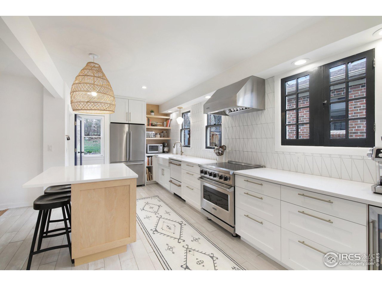 861 13th Street Boulder, CO 80302 - Photo 15 of 36 a kitchen with granite countertop a stove and a wooden floors