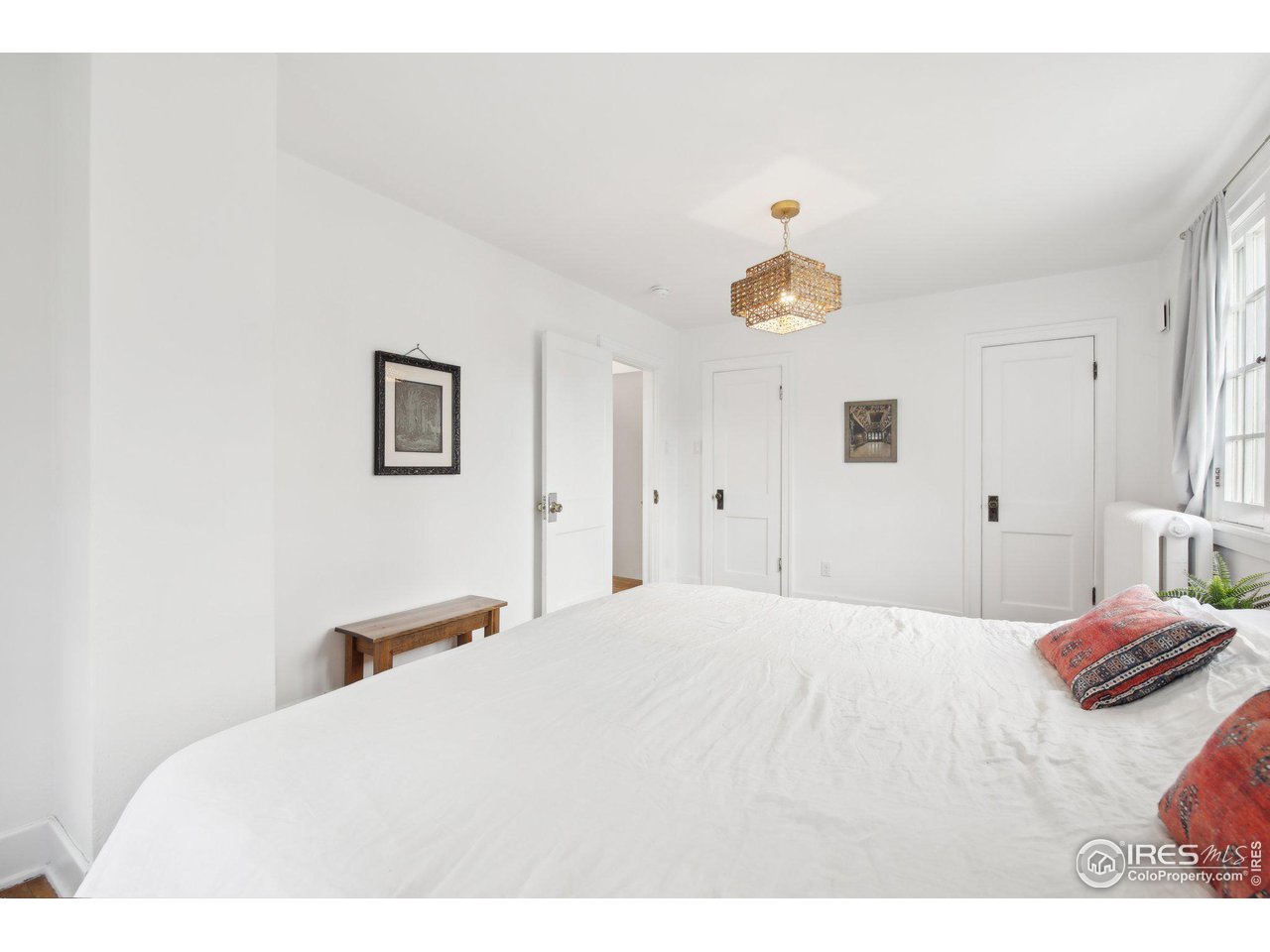 861 13th Street Boulder, CO 80302 - Photo 18 of 36 a bedroom with a bed and a chandelier