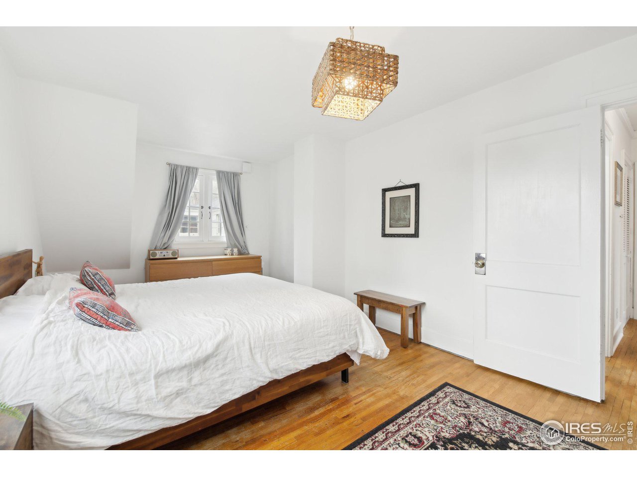 861 13th Street Boulder, CO 80302 - Photo 19 of 36 a bedroom with a bed and a painting on the wall