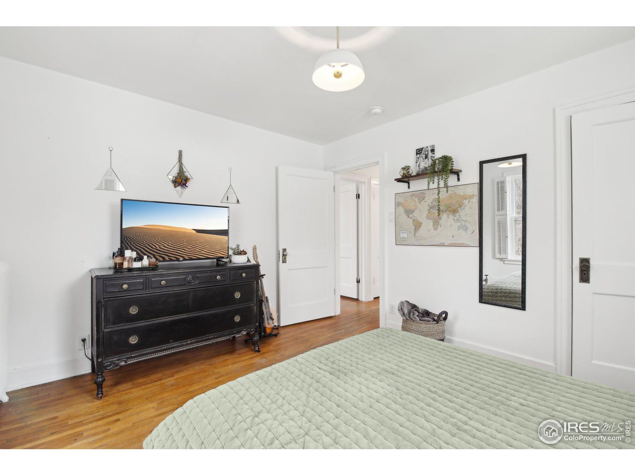 861 13th Street Boulder, CO 80302 - Photo 23 of 36 a bedroom with a bed and wooden floor