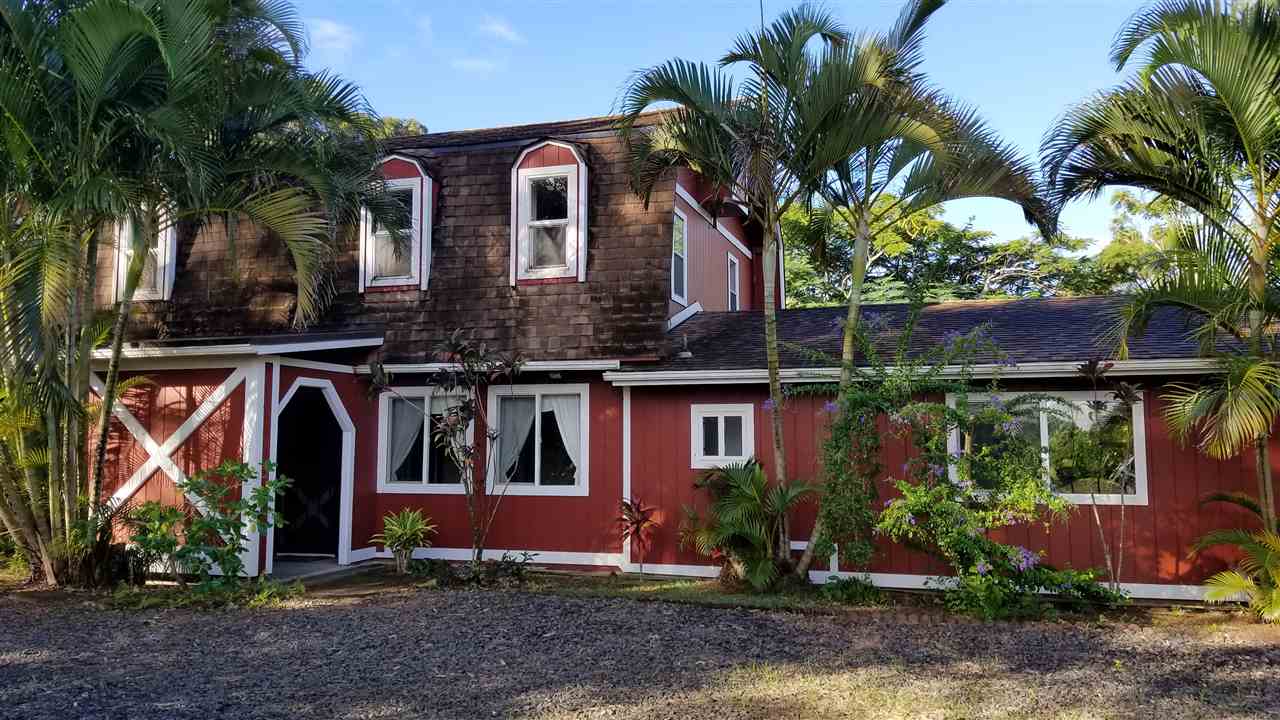 a front view of house with a garden