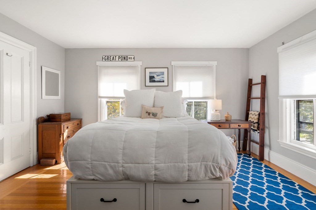 319 Sherman Street Canton, MA 02021 - Photo 18 of 29 a bedroom with a bed and wooden floor