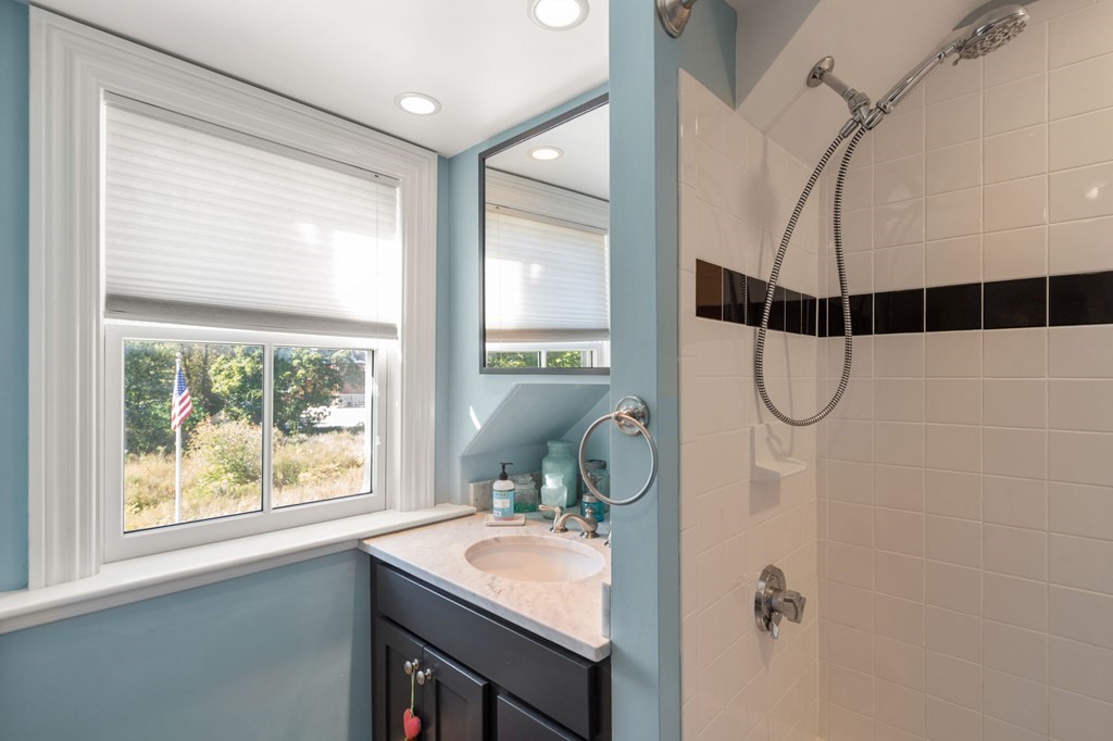 319 Sherman Street Canton, MA 02021 - Photo 21 of 29 a bathroom with a sink a window and a shower