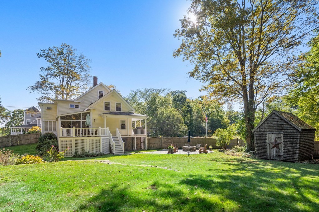 319 Sherman Street Canton, MA 02021 - Photo 28 of 29 a view of a brick house with a big yard and large trees