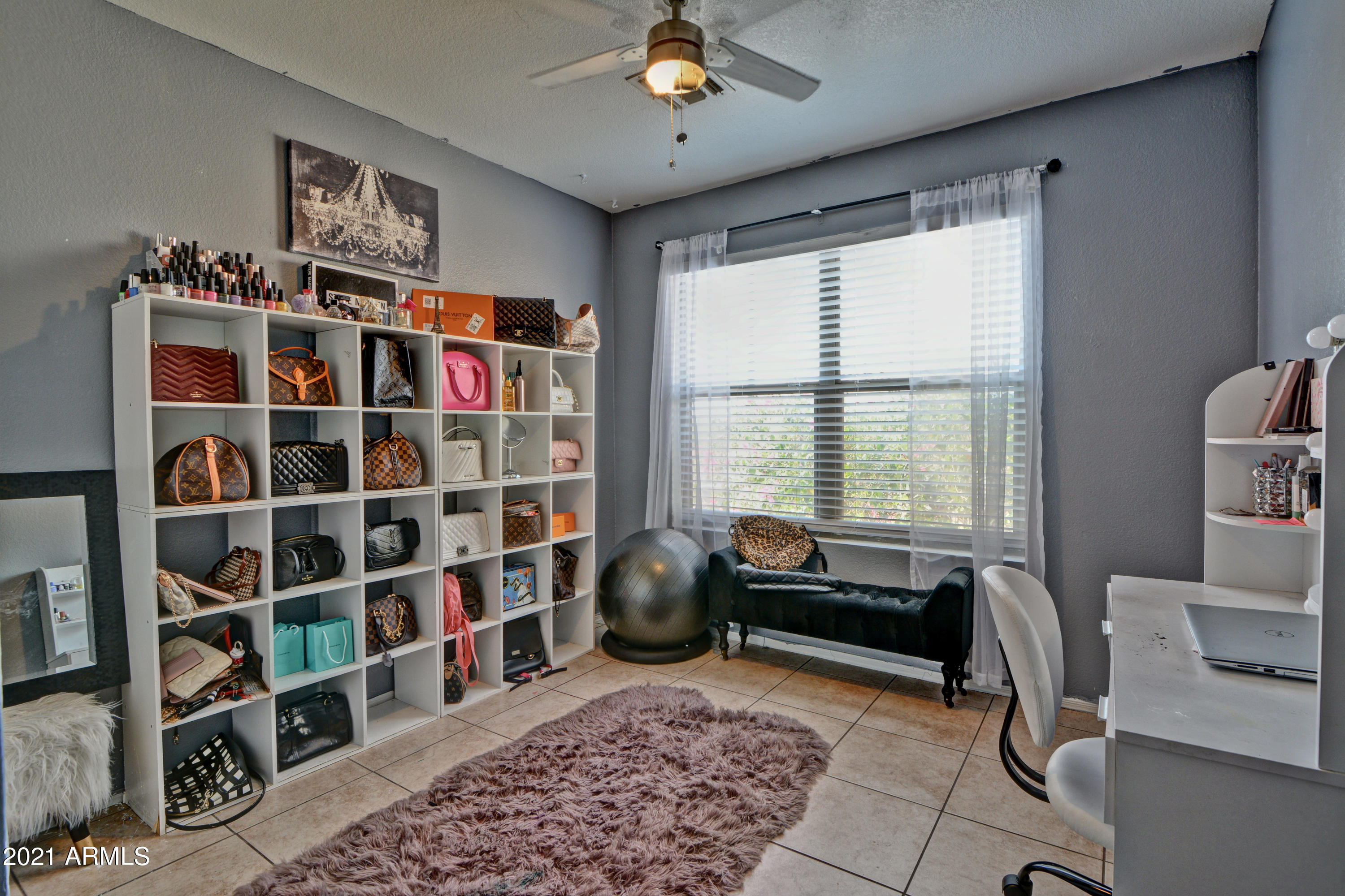 7945 West Hatcher Road Peoria, AZ 85345 - Photo 11 of 15 a living room with furniture and a book shelf