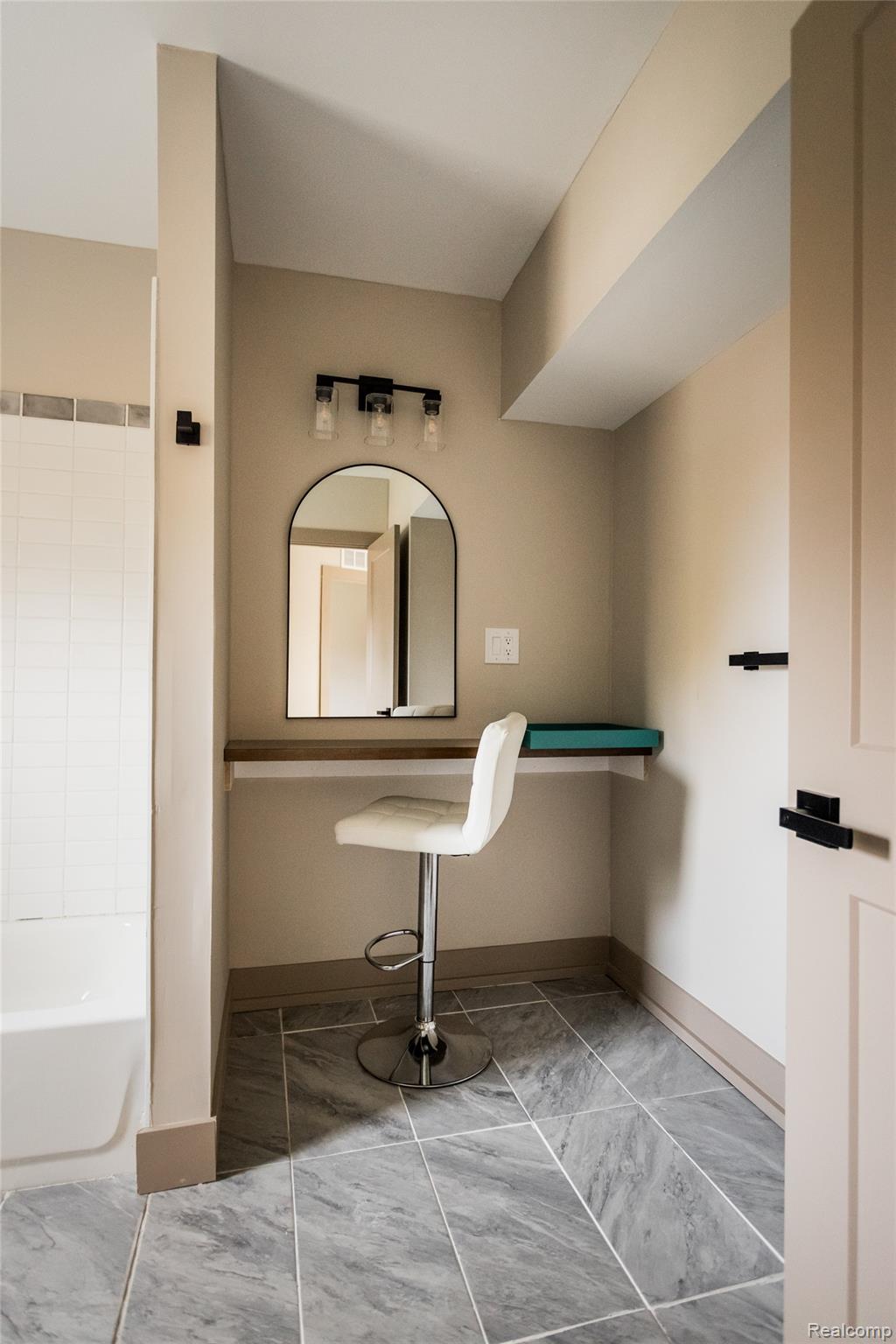 2630 Harding Street Detroit, MI 48214 - Photo 30 of 30 Custom vanity area featuring a wall-mounted arched mirror and three-bulb light fixture