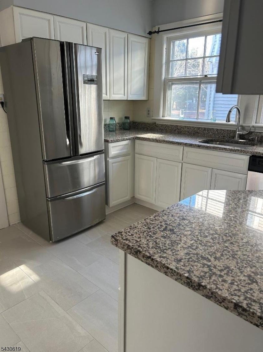 96 Grove Street Montclair, NJ 07042 - Photo 13 of 23 a kitchen with stainless steel appliances granite countertop a refrigerator sink and white cabinets